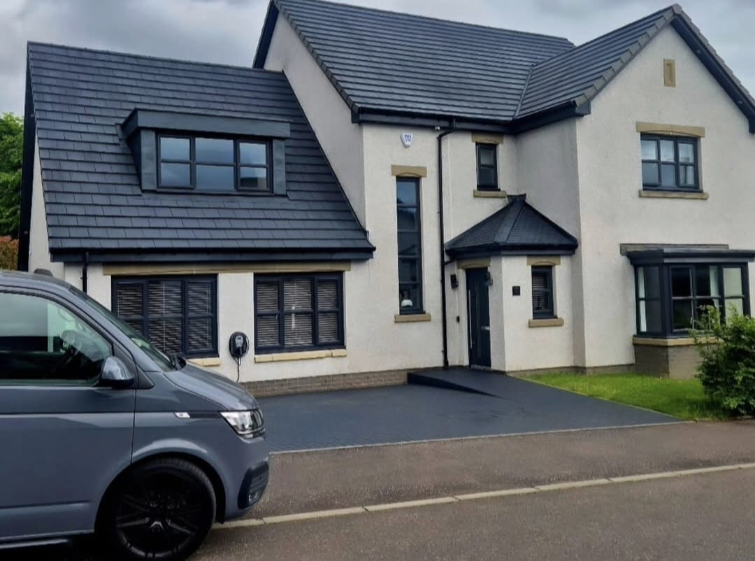 Family home with sprayed anthracite roof tiles, windows and door